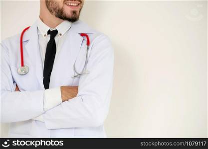 Young handsome doctor with arms crossed standing on white background. Medical and healthcare concept.
