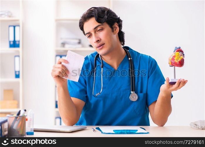 Young handsome doctor working at the clinic 