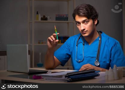 Young handsome doctor working night shift in hospital   