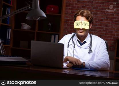 Young handsome doctor working night time at the hospital . The young handsome doctor working night time at the hospital 