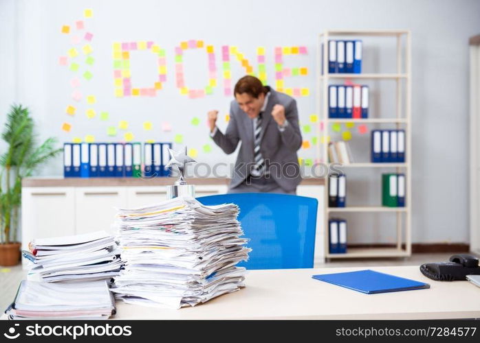 Young handsome employee sitting at the office 