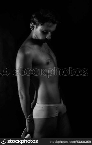 young handsome guy in shorts and white hat on black background&#xA;