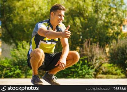 Young handsome guy in sportswear suit after outdoor workout. Fit man presenting sport fashion.. Young sporty man outdoor