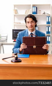 Young handsome judge sitting in courtroom   . Young handsome judge sitting in courtroom  