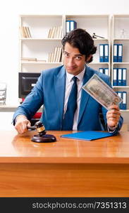 Young handsome judge sitting in courtroom   . Young handsome judge sitting in courtroom  