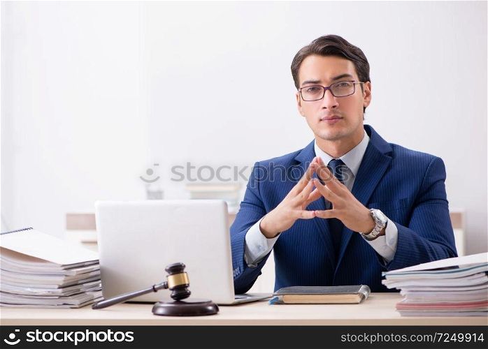 Young handsome judge working in court