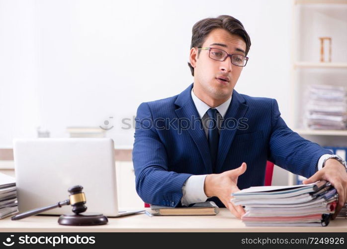 Young handsome judge working in court