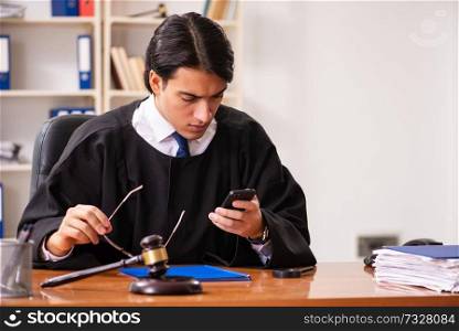 Young handsome judge working in court 