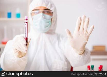 Young handsome lab assistant testing blood s&les in hospital 
