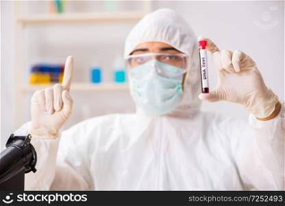 Young handsome lab assistant testing blood samples in hospital . The young handsome lab assistant testing blood samples in hospital 