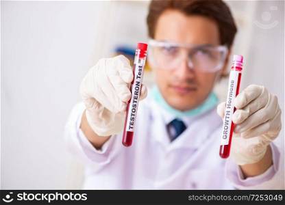 Young handsome lab assistant testing blood samples in hospital . The young handsome lab assistant testing blood samples in hospital 