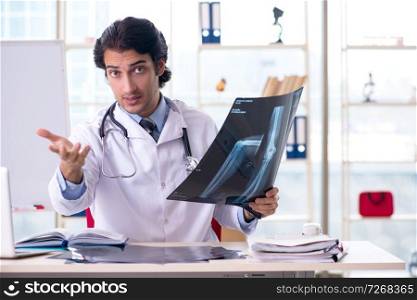 Young handsome male radiologist in front of whiteboard 
