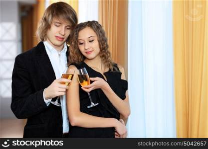 Young handsome man and pretty woman in a restaurant with shampagne