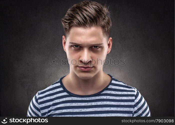 Young handsome man carefully looking straight ahead