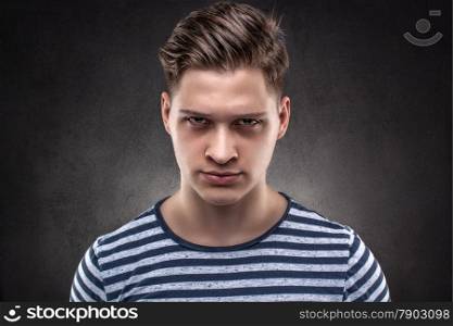 Young handsome man carefully looking straight ahead