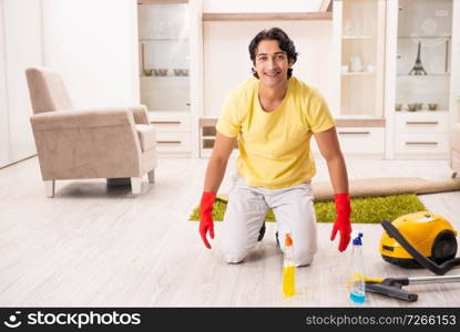 Young handsome man doing housework 