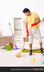 Young handsome man doing housework 