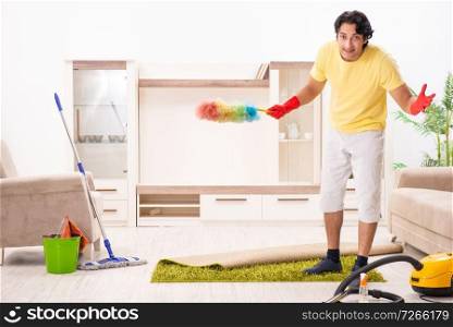Young handsome man doing housework 