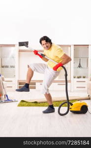 Young handsome man doing housework 