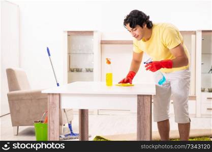 Young handsome man doing housework 