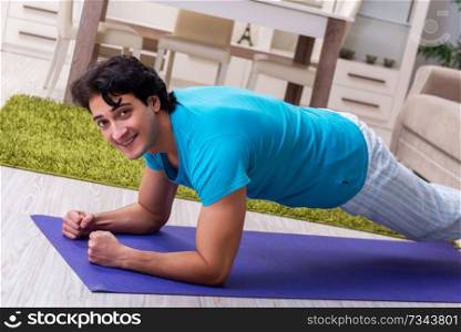 Young handsome man doing morning exercises 