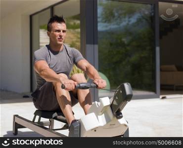young handsome man doing morning exercises in front of his luxury home villa