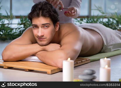 Young handsome man during spa procedure