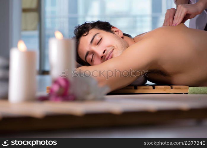 Young handsome man during spa procedure