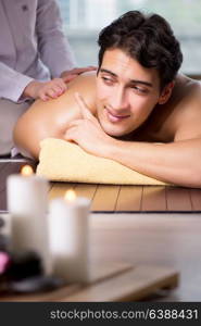 Young handsome man during spa procedure