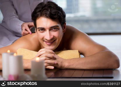 Young handsome man during spa procedure