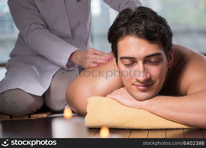 Young handsome man during spa procedure