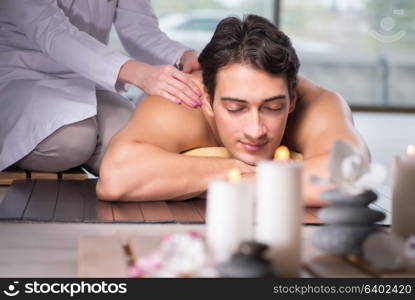 Young handsome man during spa procedure