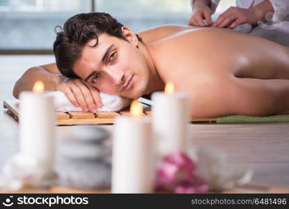 Young handsome man during spa procedure