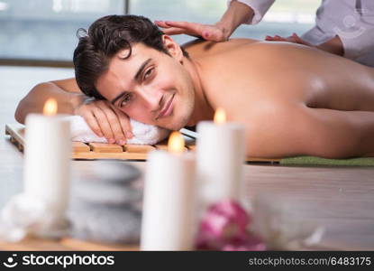 Young handsome man during spa procedure