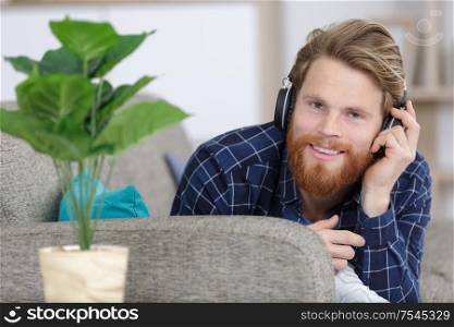 young handsome man enjoying music through headphones