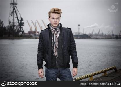 Young handsome man fashion model casual style on street urban industrial background