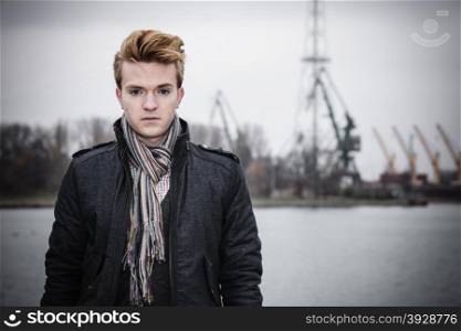 Young handsome man fashion model casual style on street urban industrial background