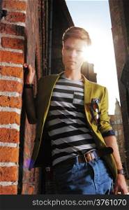 Young handsome man fashion model casual style posing on street of old town Gdansk Poland Europe