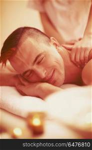 young handsome man have relaxing massage in spa and wellness salon. man have relaxing massage