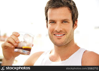Young handsome man having a drink outdoors