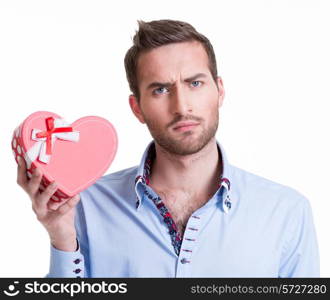 Young handsome man holding a gift and thinking - isolated on white.