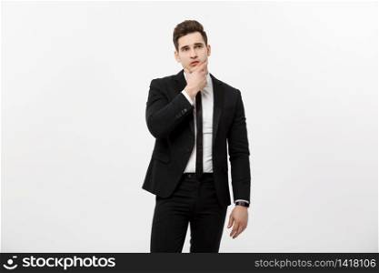 Young handsome man in black suit and glasses looking at copy-space smiling, thinking or dreaming. Business Concept: Young handsome man in black suit looking at copy-space smiling, thinking or dreaming