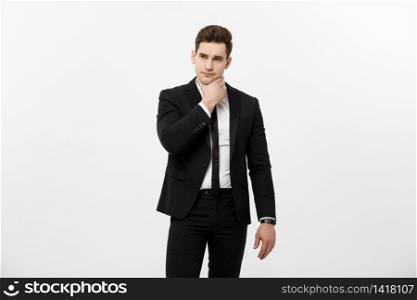 Young handsome man in black suit and glasses looking at copy-space thinking or dreaming isolated over white background.. Young handsome man in black suit and glasses looking at copy-space thinking or dreaming isolated over white background