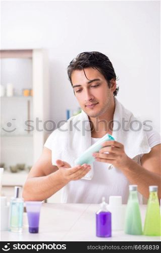 Young handsome man in the bathroom in hygiene concept . The young handsome man in the bathroom in hygiene concept 