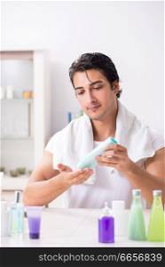 Young handsome man in the bathroom in hygiene concept . The young handsome man in the bathroom in hygiene concept 
