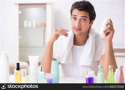 Young handsome man in the bathroom in hygiene concept 