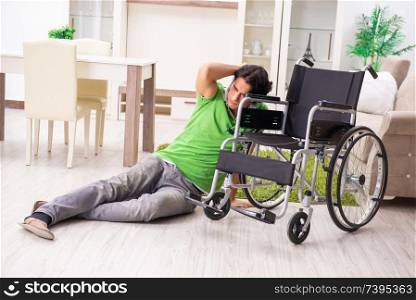 Young handsome man in wheelchair at home 