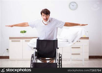 Young handsome man in wheelchair at the hospital 