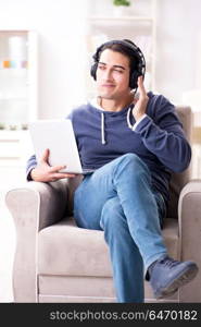 Young handsome man listening to music with headphones