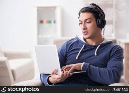 Young handsome man listening to music with headphones